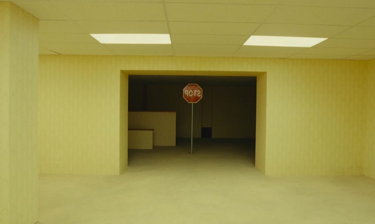 A STOP sign with mirror-reversed lettering in a yellow room